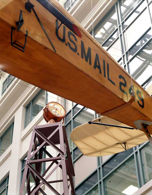 a beacon light on display at the museum behind the wing of a DeHavilland DH-4 aircraft