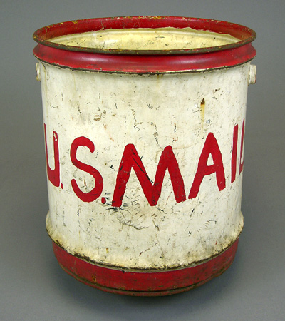 weathered five-gallon red and white steel mail pail