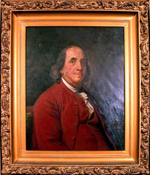painting of Benjamin Franklin in an ornate gold frame
