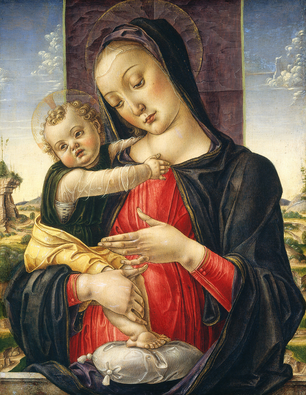 Peinture à la détrempe de la Vierge à l'enfant. Les pieds de l'enfant reposent sur un oreiller.