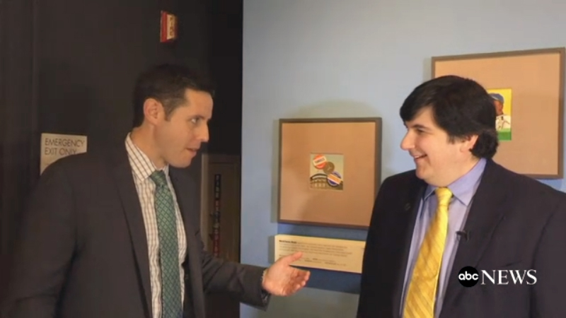 Screenshot of news person interviewing a museum curator in a gallery