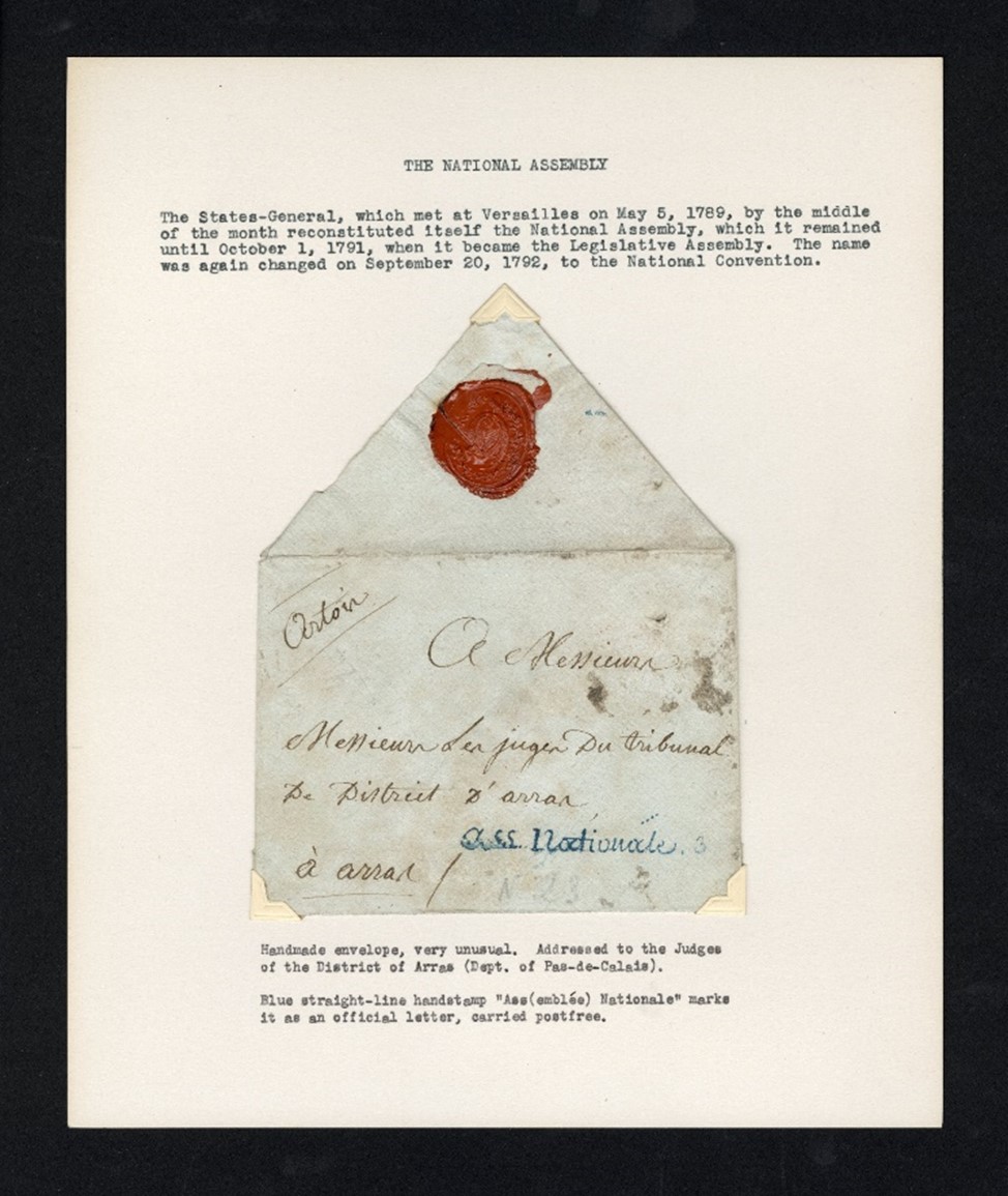 Photograph of page of album with envelope with red wax seal adhered to page; above, typed text describing the envelope 