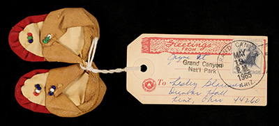 Small moccasins with an attached mailing label