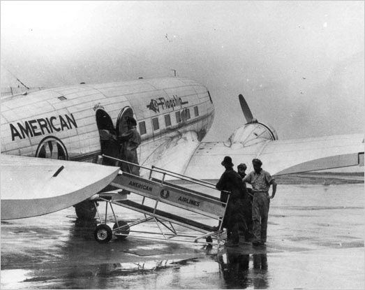 people boarding a DC-3 plane