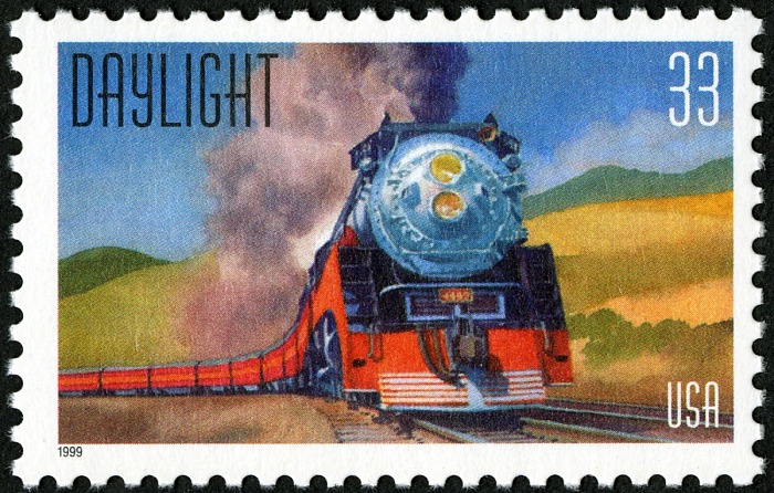 Daylight train stamp depicting a locomotive pulling train cars through countryside