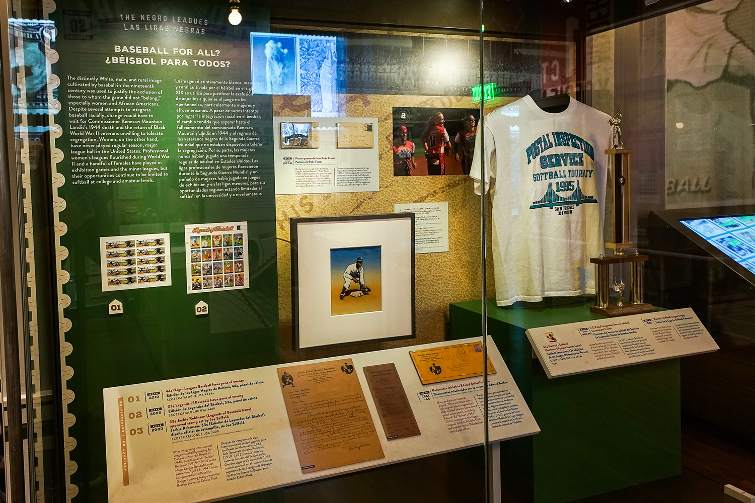 Display case containing memorabilia in the wood-paneled Postmasters Suite gallery