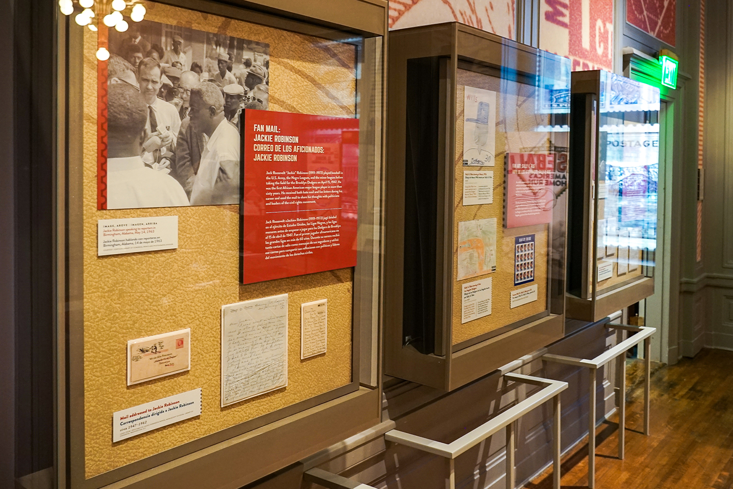 Three museum display cases with objects related to fan mail and baseball players.