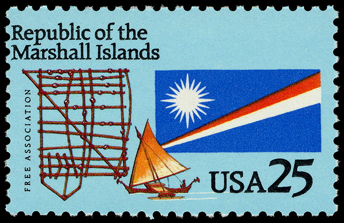 Republic of the Marshall Islands stamp featuring a flag, a traditional sailboat, and a navigational stick chart