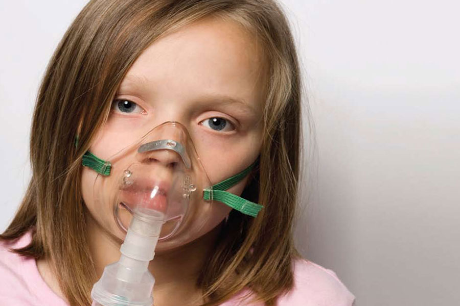 Girl wearing oxygen mask