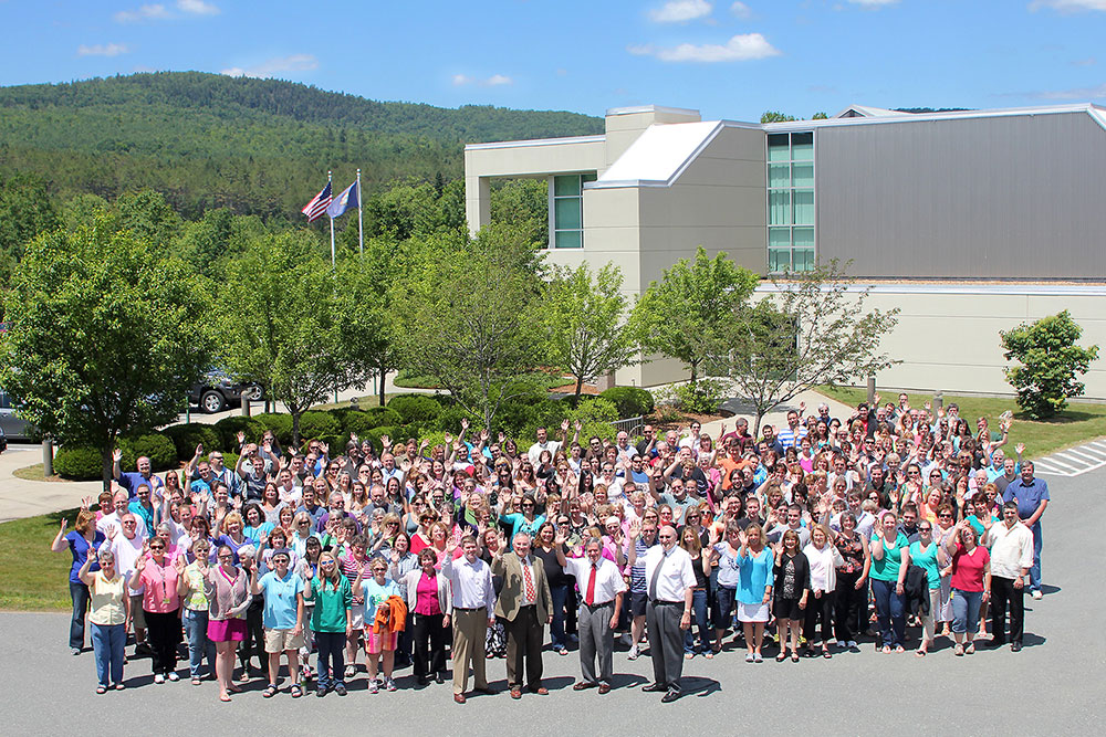 Over 320 Littleton Coin Company employees standing in front of the New Hampshire headquarters.
