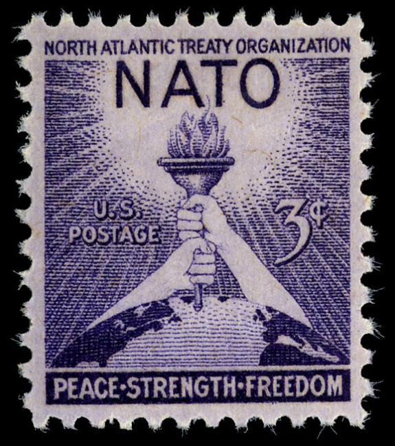 3-cent stamp with illustration of two hands holding a torch above a globe