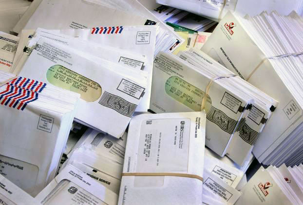 a pile of stuffed business letters