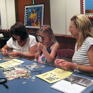 Visitors looking at stamps