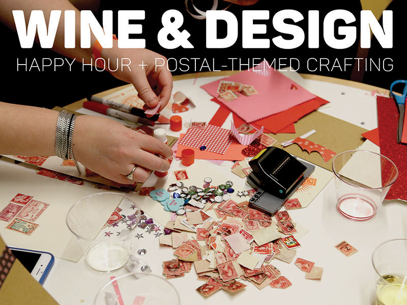 A table filled with stamps, craft materials, and an empty wine cup.